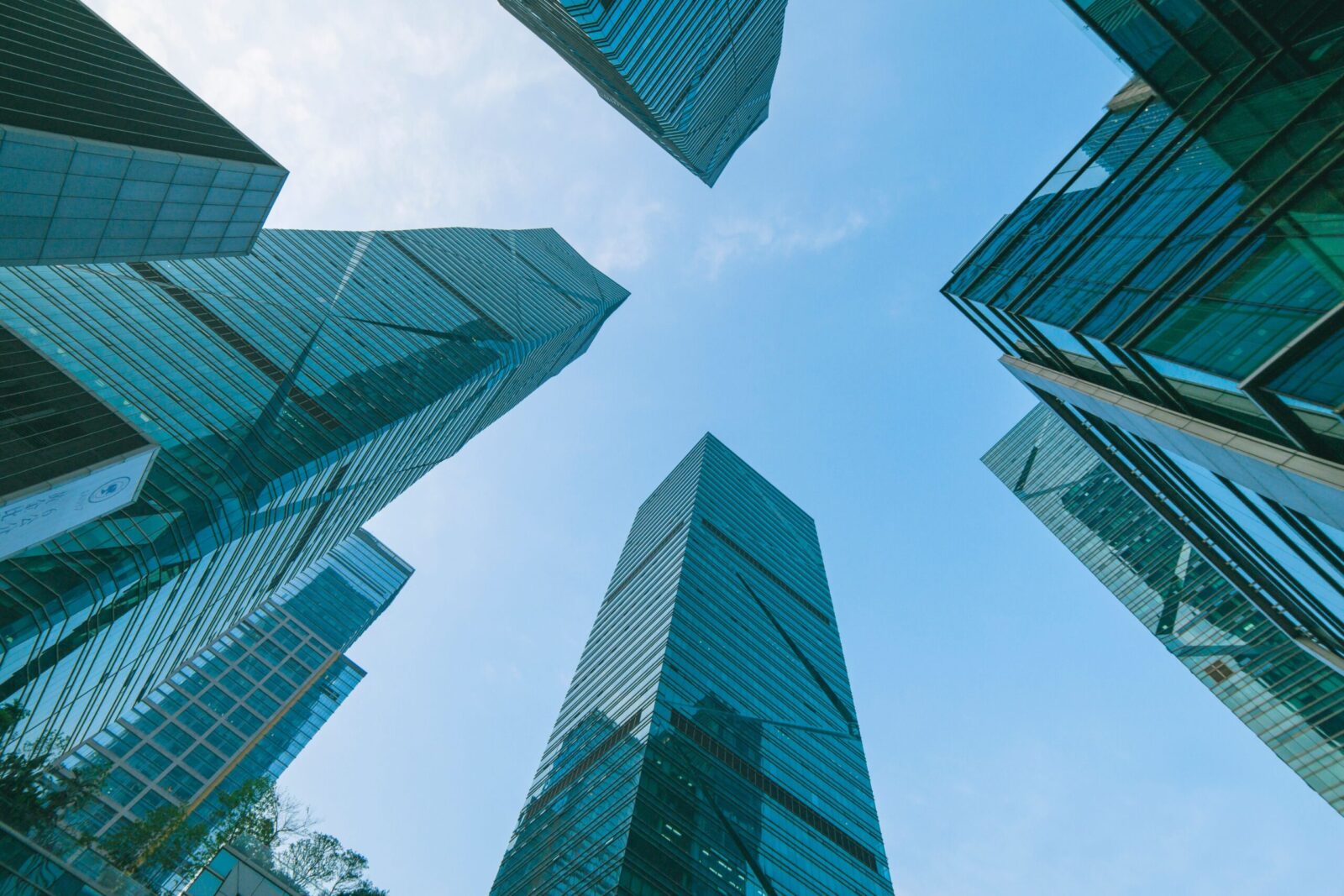 Low angle view of contemporary skyscrapers in Shenzhen, China under a clear blue sky.
